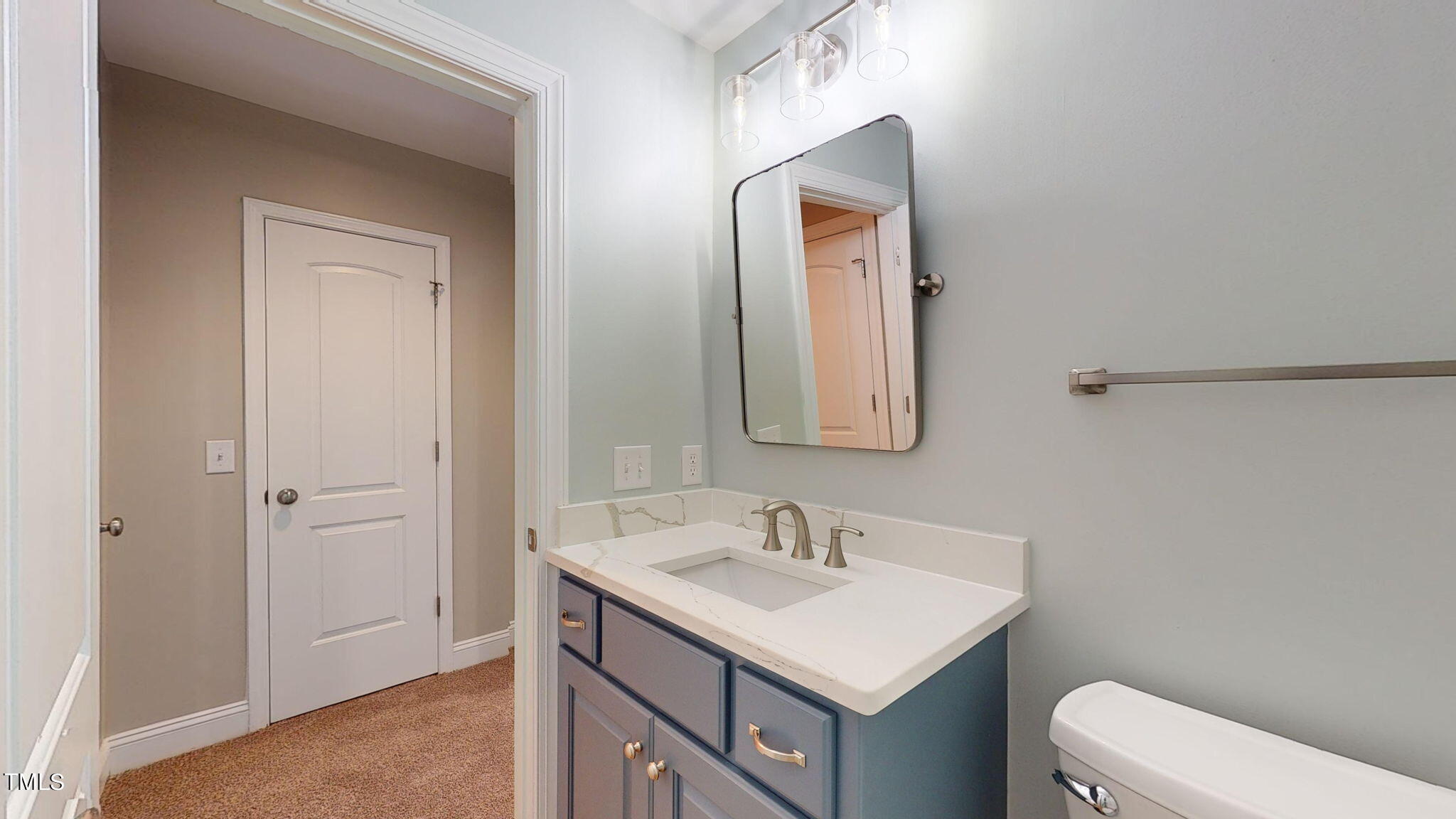 5813 Turner Store Lane Raleigh, NC 27603 - Photo 29 of 35 a bathroom with a sink a toilet and mirror