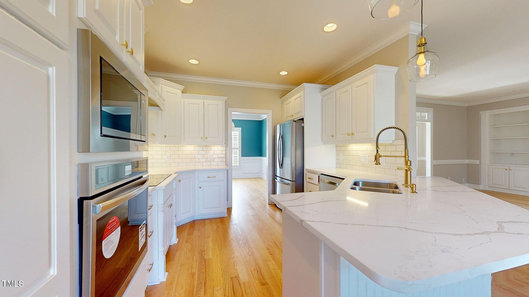 5813 Turner Store Lane Raleigh, NC 27603 - Photo 6 of 35 a kitchen with stainless steel appliances granite countertop a sink and a stove top oven with wooden floor