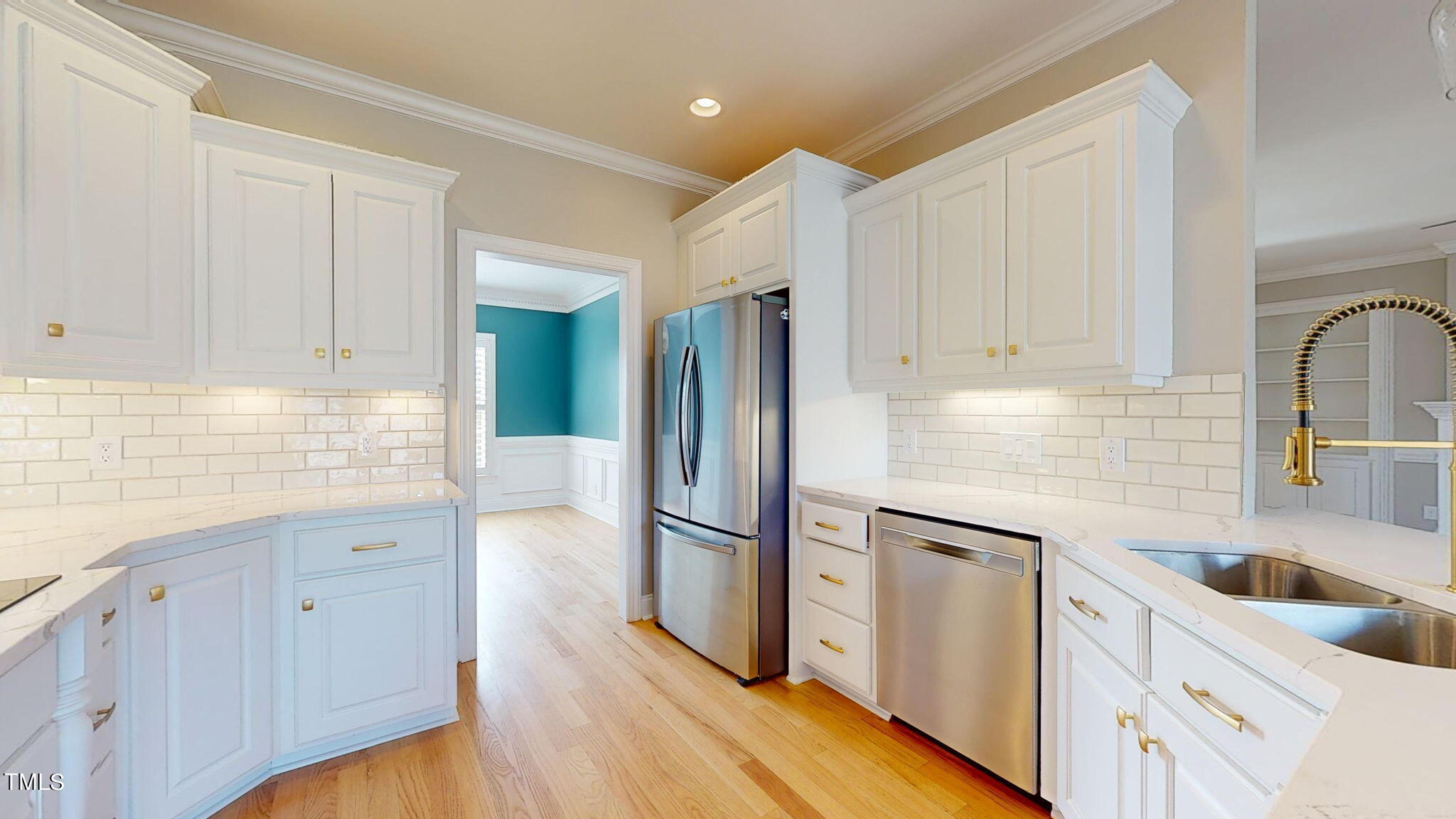 5813 Turner Store Lane Raleigh, NC 27603 - Photo 7 of 35 a kitchen with granite countertop a refrigerator sink and white cabinets