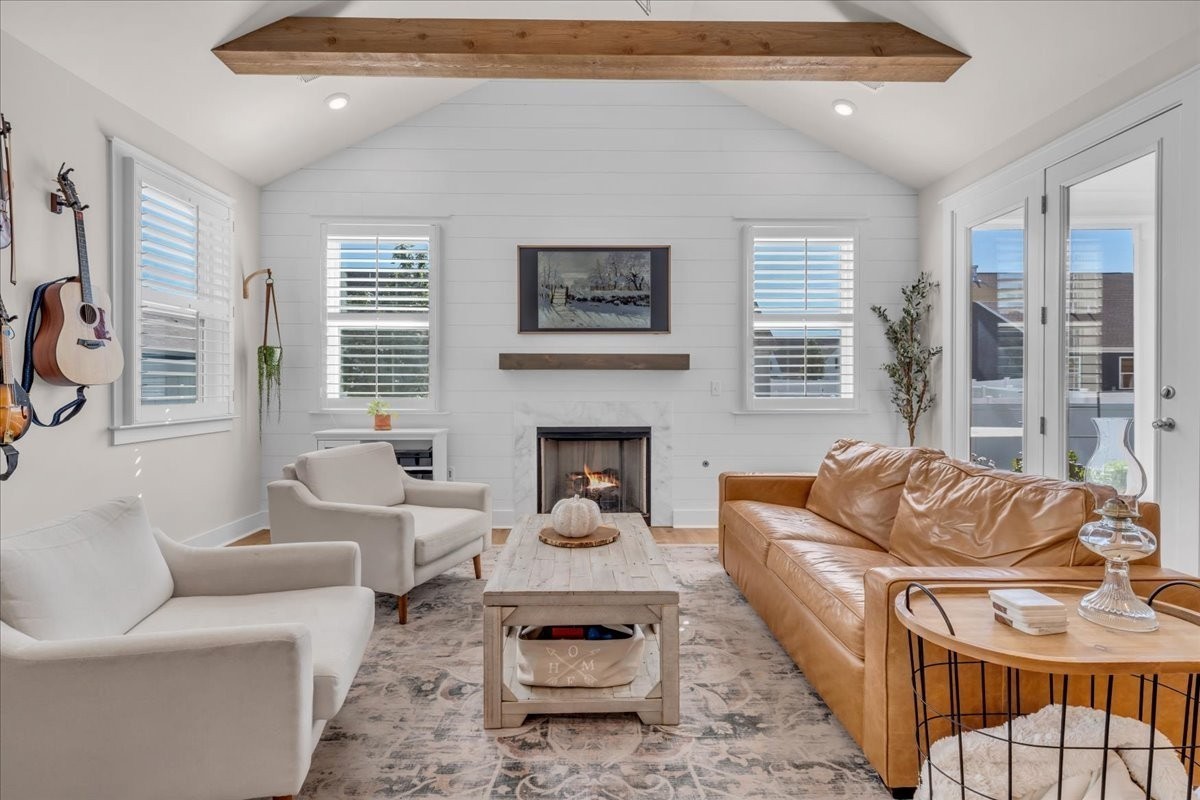 a living room with furniture a fireplace and a table