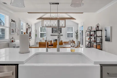 a living room with lots of furniture and a chandelier