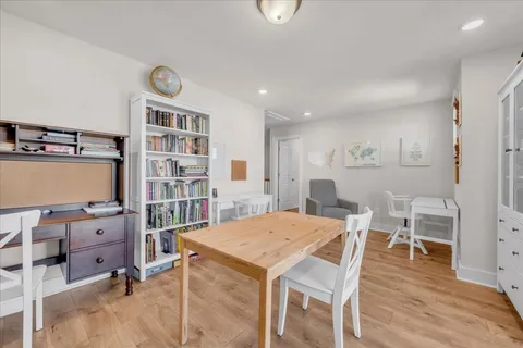 a view of a dining room with furniture and wooden floor