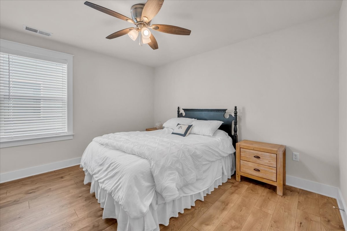 5116 Bridgemore Boulevard Murfreesboro, TN 37129 - Photo 21 of 38 a bedroom with a bed and a chandelier