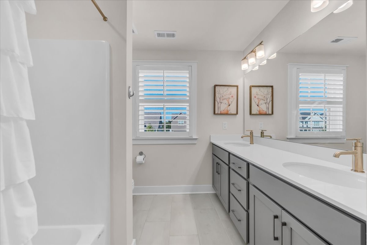 5116 Bridgemore Boulevard Murfreesboro, TN 37129 - Photo 25 of 38 a spacious bathroom with a double vanity sink a mirror and a bathtub