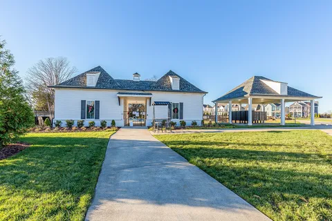 a front view of a house with swimming pool having outdoor seating