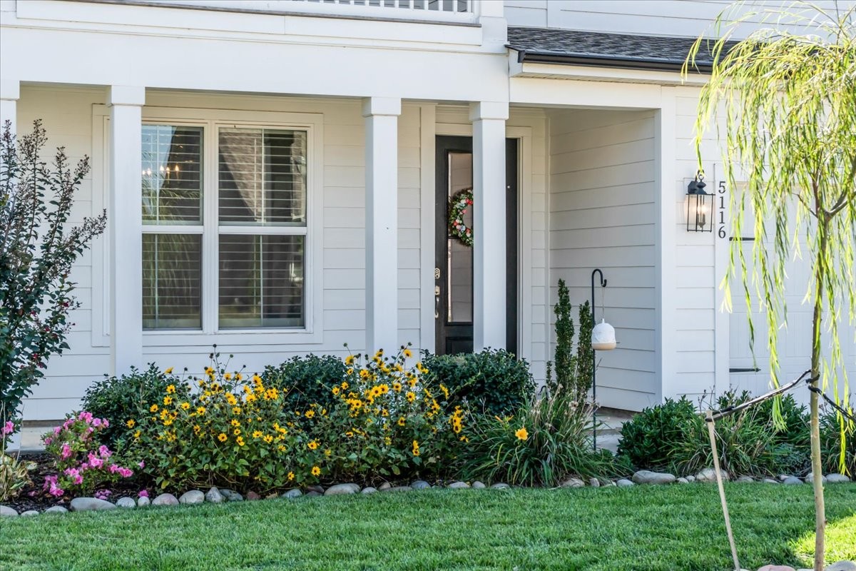 5116 Bridgemore Boulevard Murfreesboro, TN 37129 - Photo 5 of 38 a view of a house with potted plants and a bench