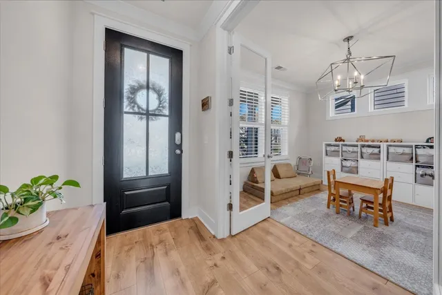 a living room with furniture and a chandelier