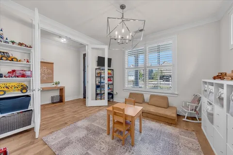 a living room with furniture and a chandelier