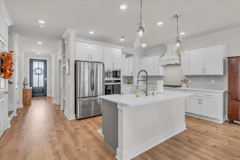 a kitchen with refrigerator and cabinets