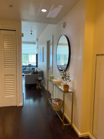 a living room with furniture and a mirror