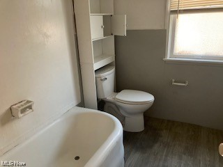1508 Genesee Road South Euclid, OH 44121 - Photo 10 of 12 Bathroom with a bath to relax in and dark hardwood floors