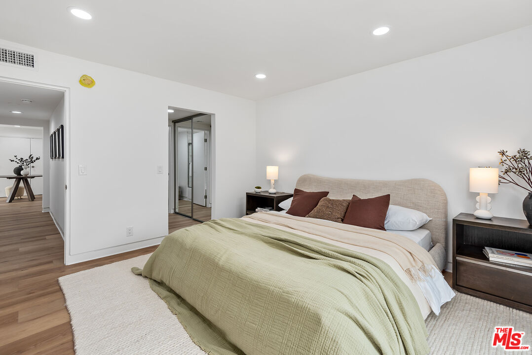 301 South Rexford Drive, Unit 2 Beverly Hills, CA 90212 - Photo 12 of 23 a spacious bedroom with a bed and a couch