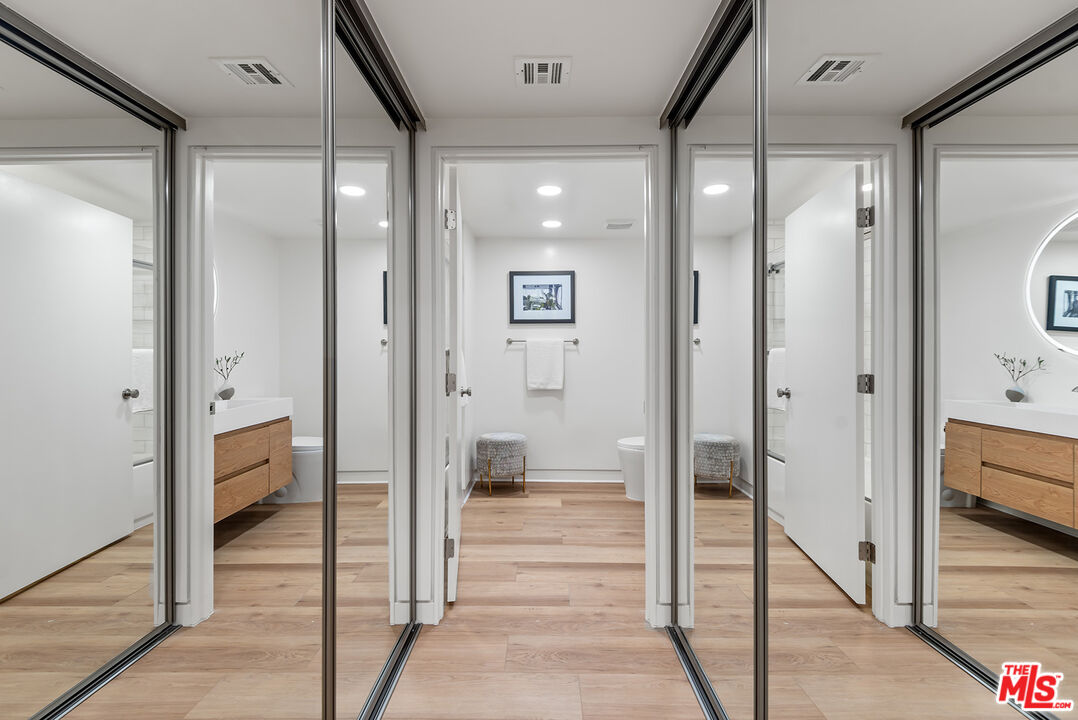 301 South Rexford Drive, Unit 2 Beverly Hills, CA 90212 - Photo 13 of 23 a view of a hallway with bathroom and wooden floor