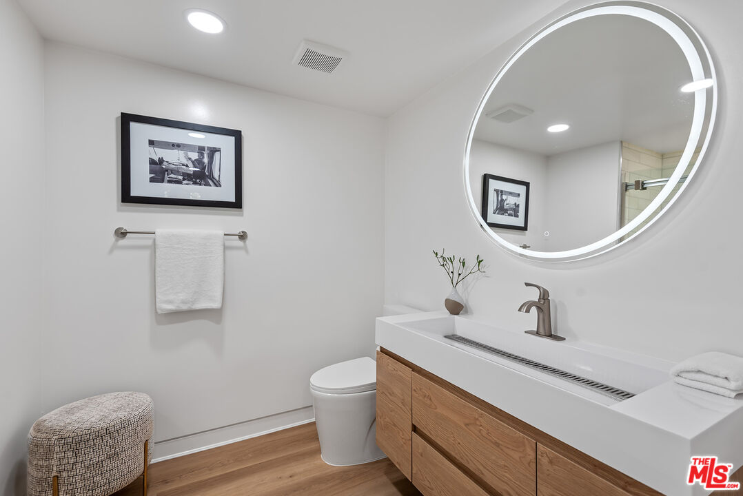 301 South Rexford Drive, Unit 2 Beverly Hills, CA 90212 - Photo 14 of 23 a bathroom with a toilet sink and mirror