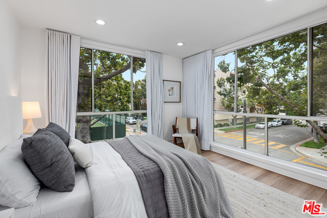 301 South Rexford Drive, Unit 2 Beverly Hills, CA 90212 - Photo 15 of 23 a bedroom with a bed and a large window