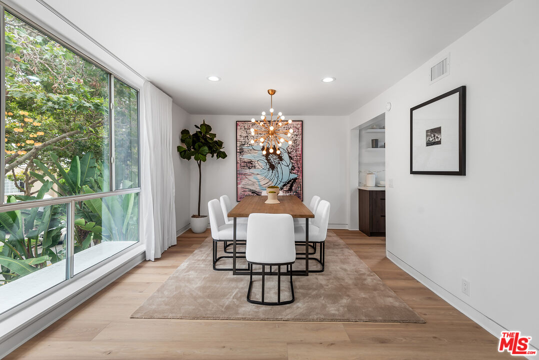 301 South Rexford Drive, Unit 2 Beverly Hills, CA 90212 - Photo 3 of 23 a dining room with furniture and wooden floor