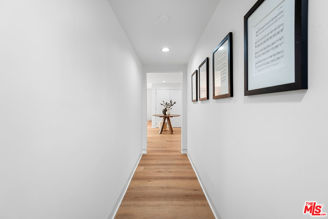 301 South Rexford Drive, Unit 2 Beverly Hills, CA 90212 - Photo 8 of 23 a view of a hallway with wooden floor and staircase