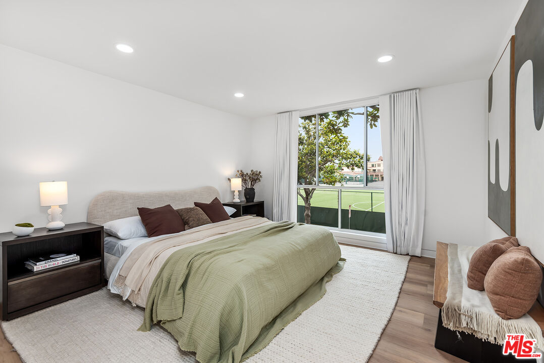 301 South Rexford Drive, Unit 2 Beverly Hills, CA 90212 - Photo 10 of 23 a spacious bedroom with a bed and a large window