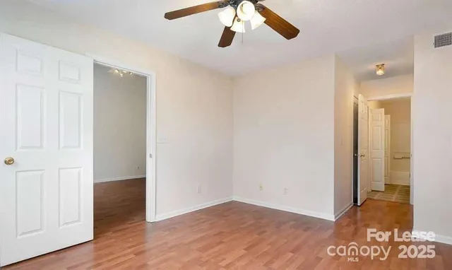 a view of an empty room and wooden floor