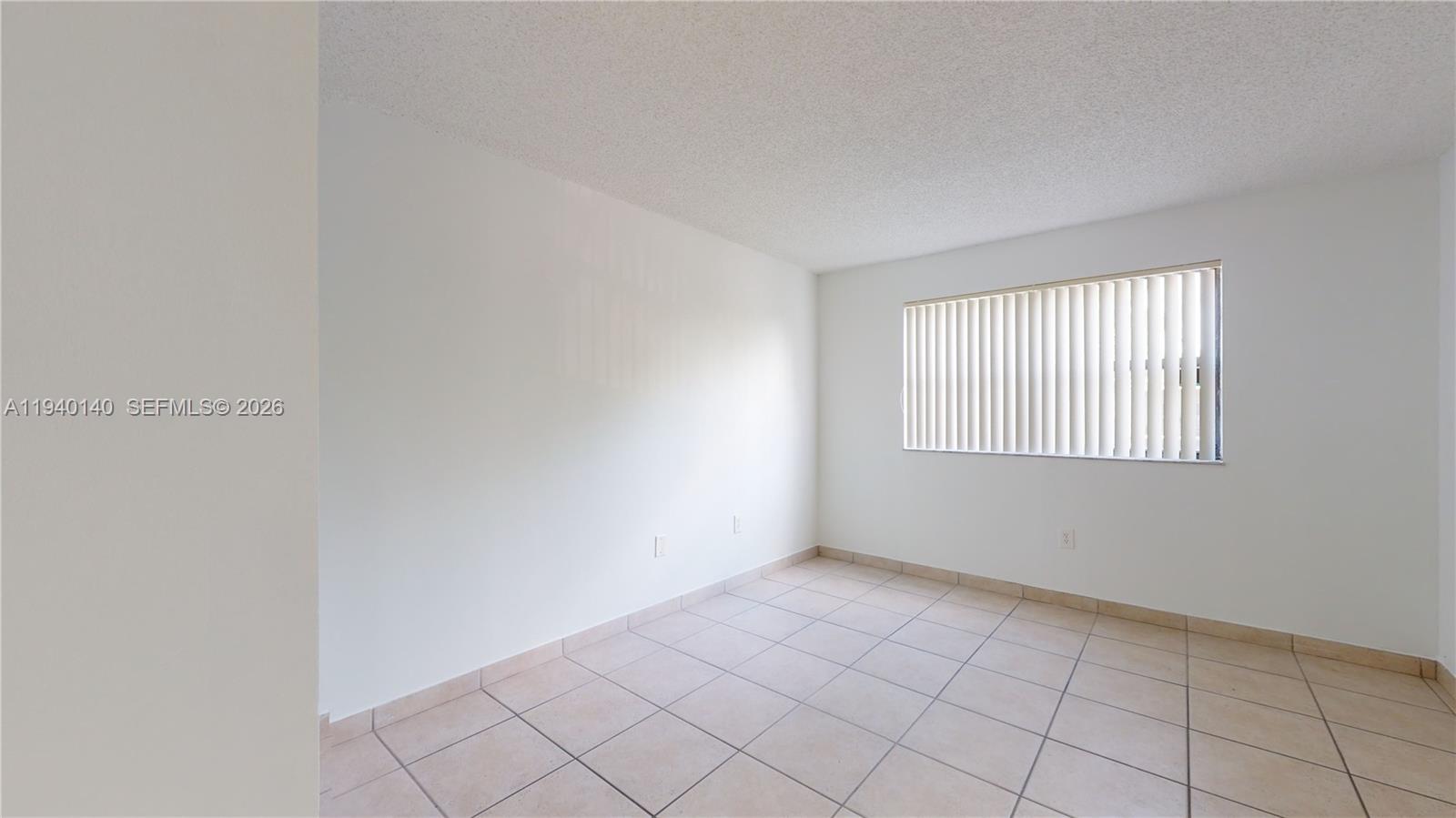15600 Southwest 80th Street, Unit L202 Miami, FL 33193 - Photo 11 of 18 a view of an empty room with window