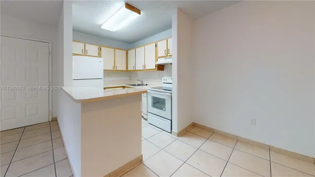 a kitchen with a stove a sink and a refrigerator