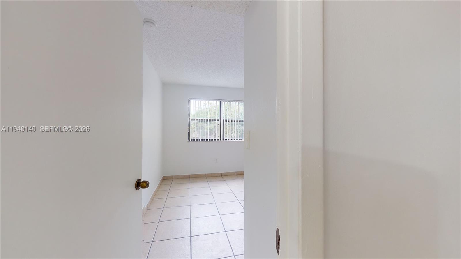 15600 Southwest 80th Street, Unit L202 Miami, FL 33193 - Photo 5 of 18 a view of an empty room with a window