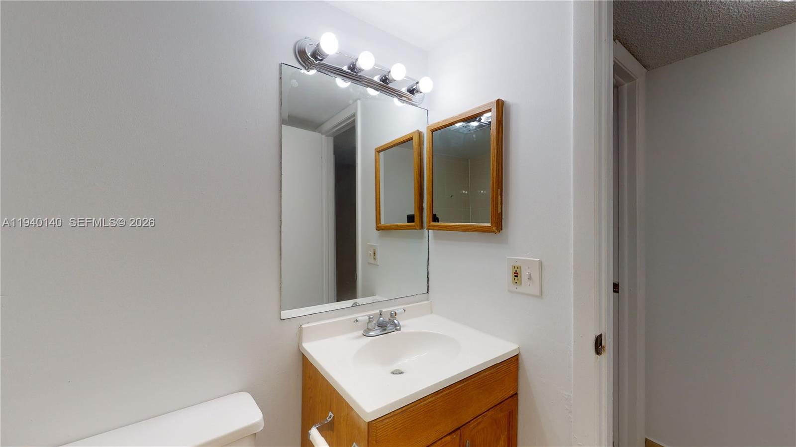 15600 Southwest 80th Street, Unit L202 Miami, FL 33193 - Photo 8 of 18 a bathroom with a sink and a mirror