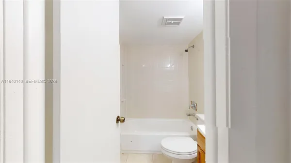 a bathroom with a toilet a sink and bathtub