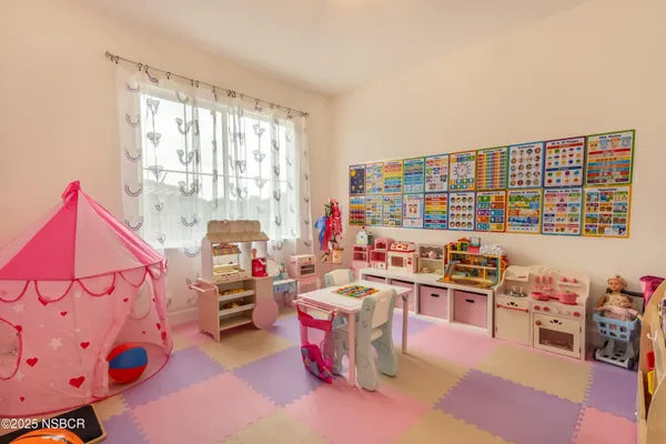 a balcony with table and chairs