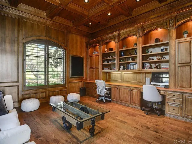 a spacious bedroom with a bed couch and a large window