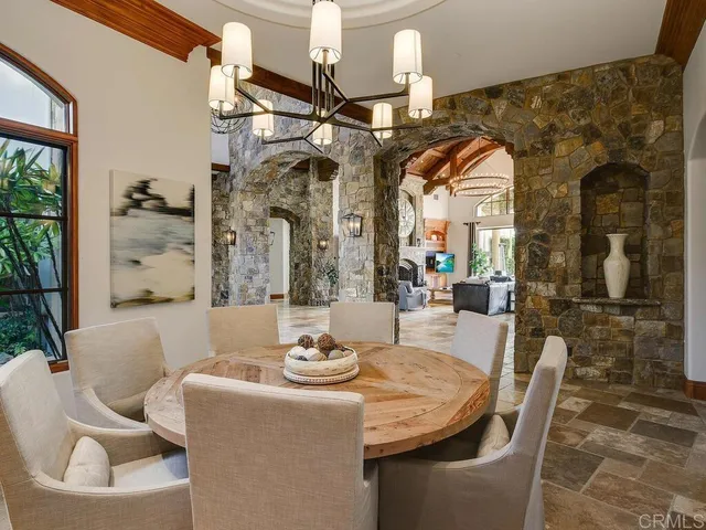 a living room with fireplace furniture and a rug