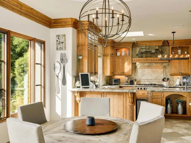 a open kitchen with stainless steel appliances granite countertop a stove and refrigerator