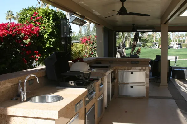a kitchen with a stove a sink and a cabinets