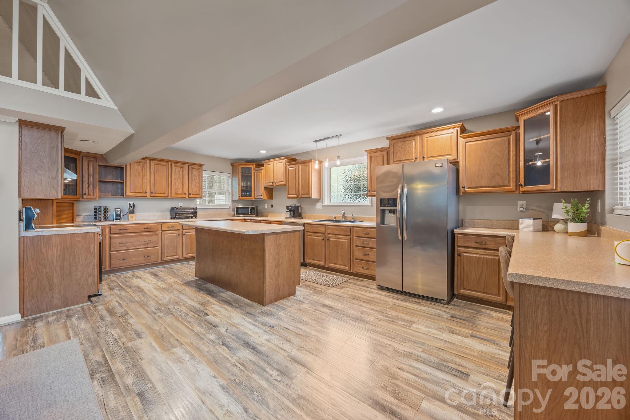 1870 Scout Road Salisbury, NC 28146 - Photo 2 of 48 a large kitchen with stainless steel appliances granite countertop a stove a sink dishwasher a refrigerator and a oven with wooden floor
