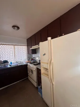 a kitchen with a refrigerator a stove a sink dishwasher and a stove