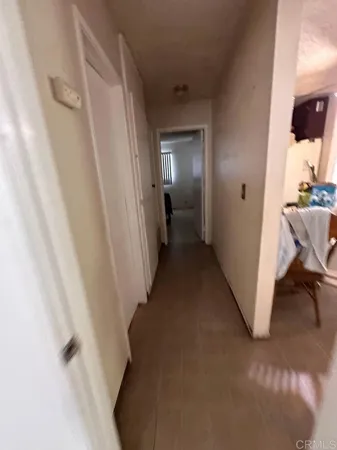 a view of a hallway with a white walls and stairs