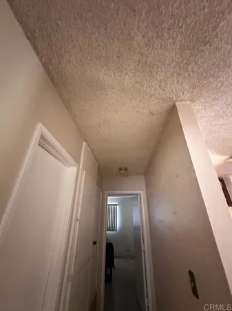an empty room with a empty space and windows