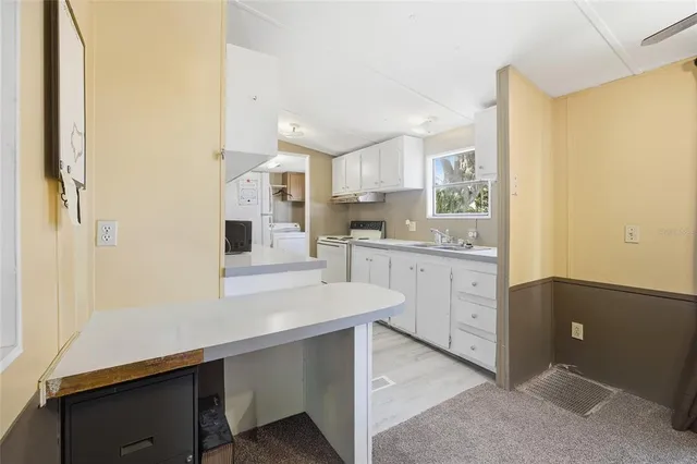 a bathroom with a tub a sink and mirror