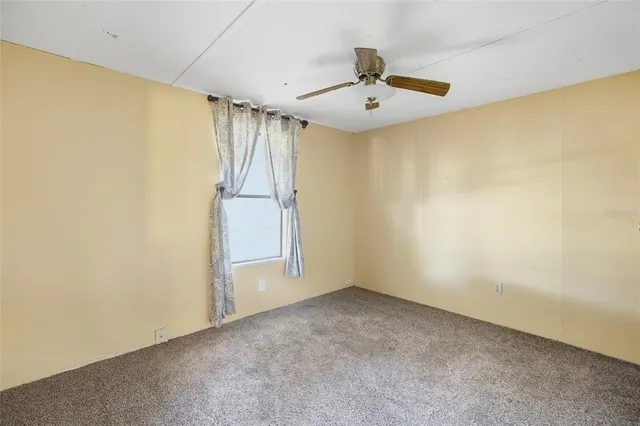 an aerial view of ocean beach and residential houses with outdoor space