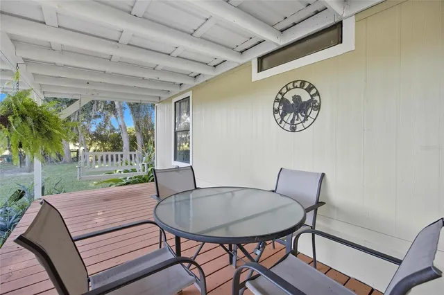 a view of swimming pool with lawn chairs and a yard