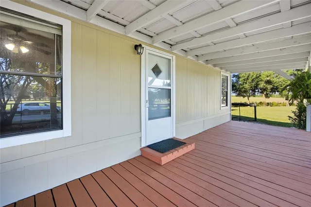 a view of backyard with swimming pool and seating
