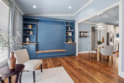a living room with furniture and wooden floor