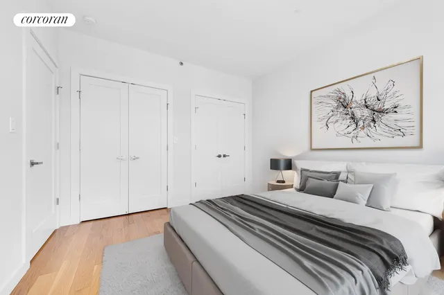 a bedroom with a bed and a painting on the wall