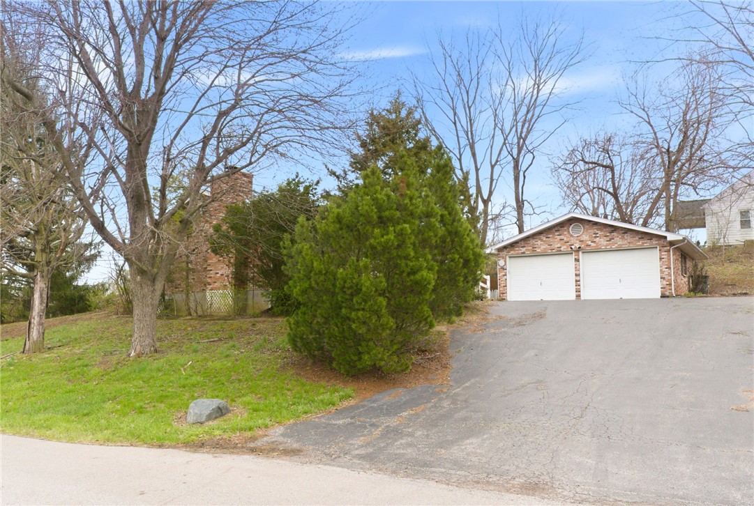 6711 Hamilton-Middletown Road Franklin, OH 45005 - Photo 28 of 49 This charming residence features a classic brick garage with ample parking space and a beautiful chimney.
