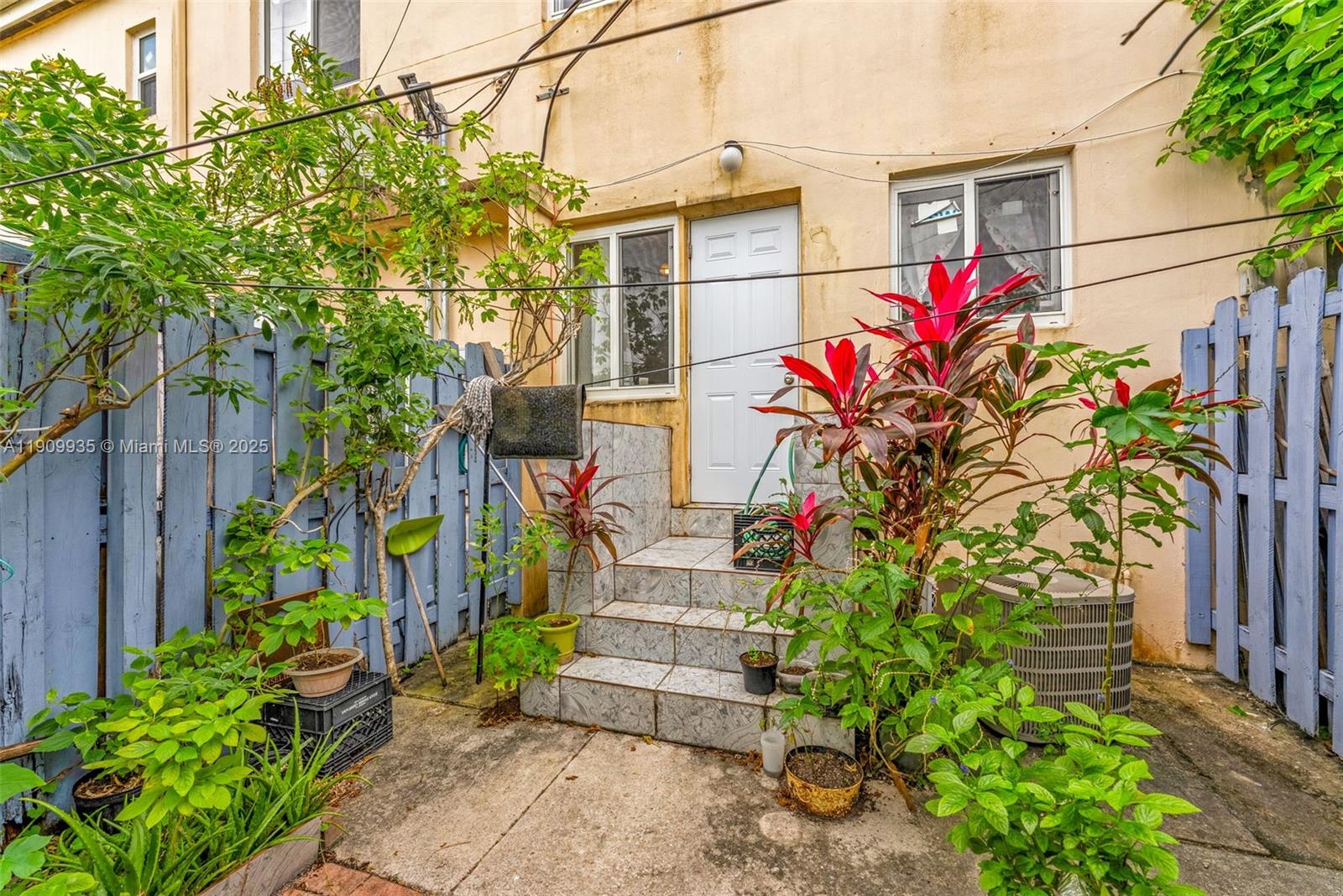427 Northwest 84th Terrace, Unit 427 Miami, FL 33150 - Photo 20 of 40 a front view of a house with plants