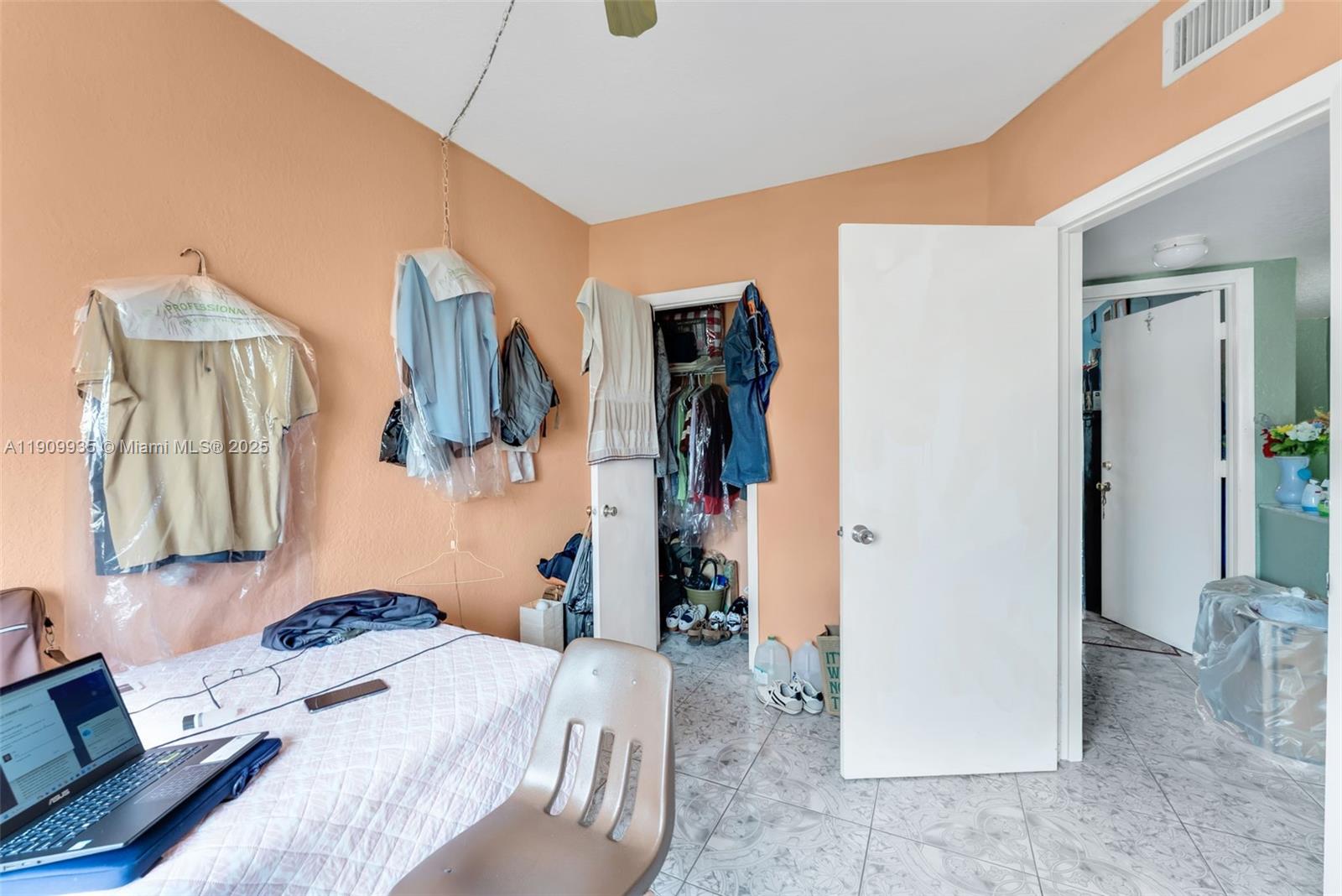 427 Northwest 84th Terrace, Unit 427 Miami, FL 33150 - Photo 29 of 40 a bedroom with a bed and a couch