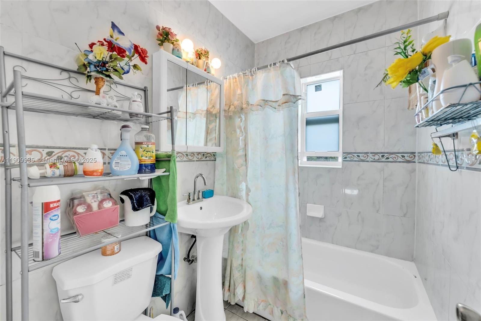 427 Northwest 84th Terrace, Unit 427 Miami, FL 33150 - Photo 35 of 40 a bathroom with a sink a toilet and shower