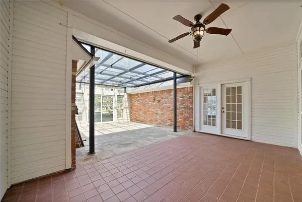 a view of a livingroom with a ceiling fan and window
