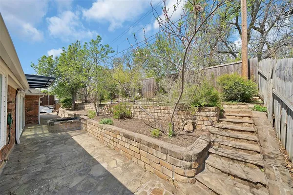 a view of yard with patio