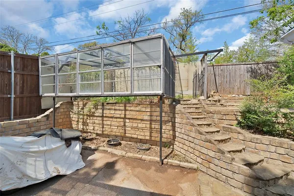 a view of a brick house with a backyard
